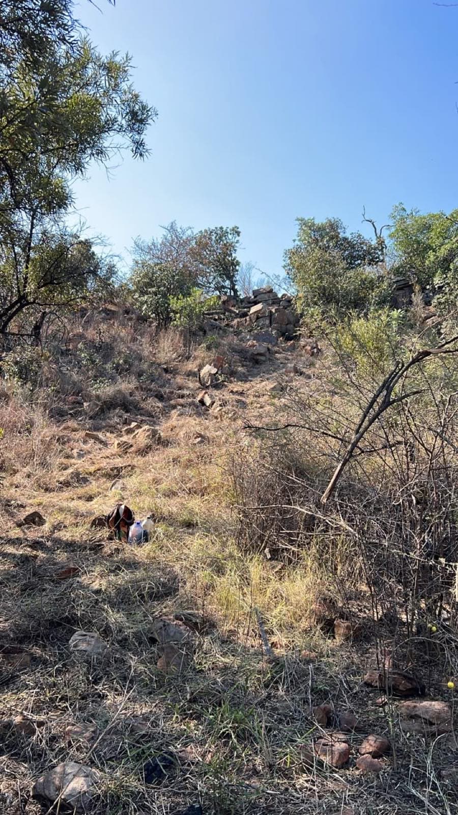 Loose rocky climb rising to a stone ledge